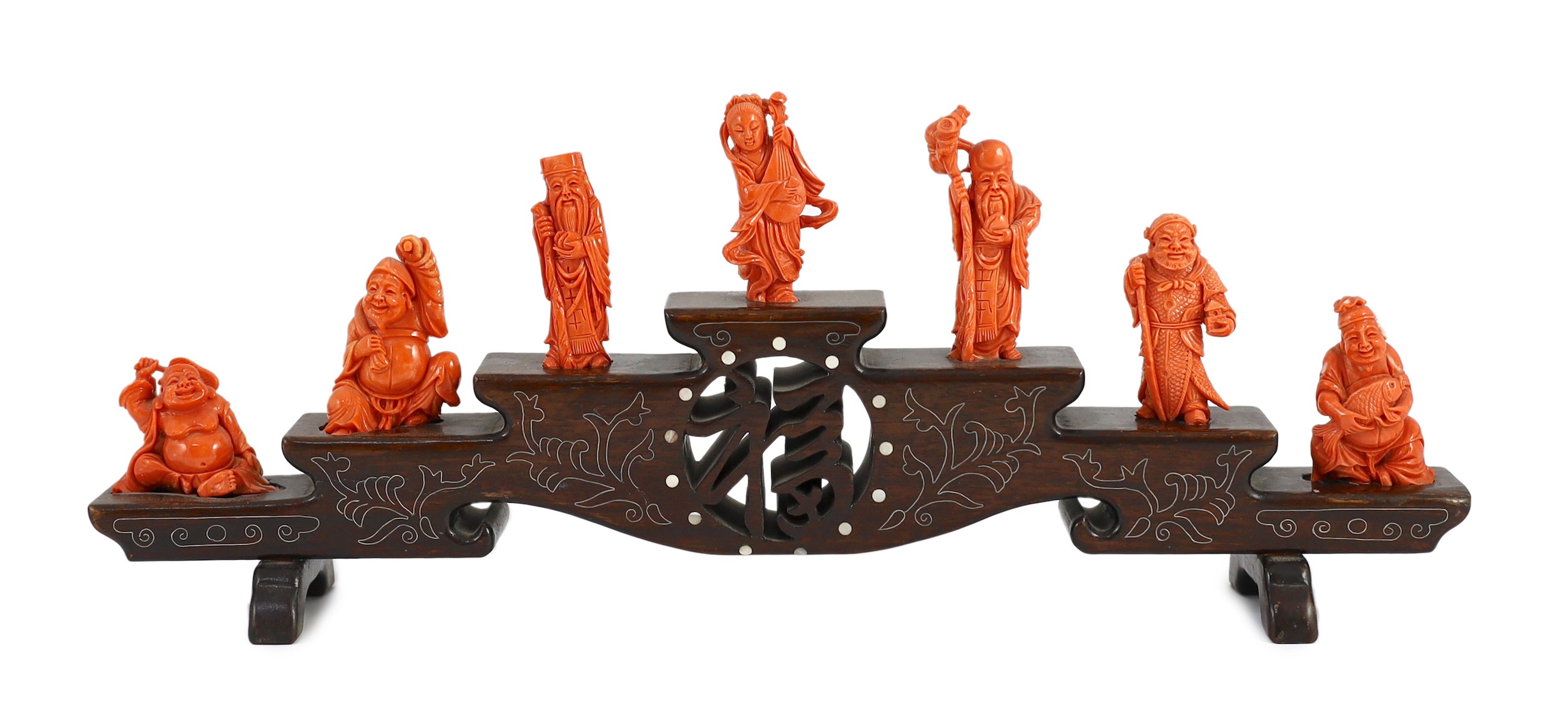 A Chinese or Japanese set of seven coral figures of immortals, 43cm wide, figures 4 to 8cm high